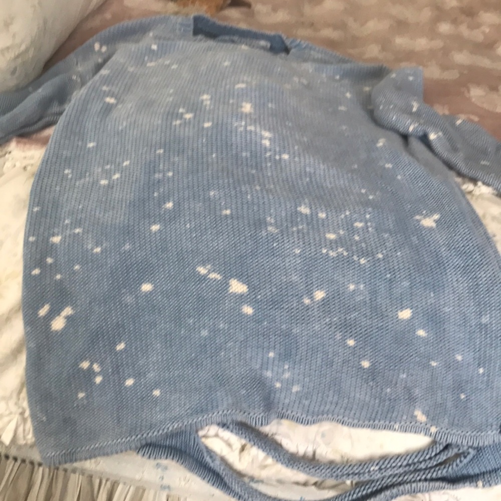 Light blue and white sweater.